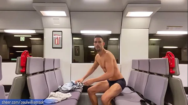 Sexy tanned man travelling naked by train. Very risky public nudity